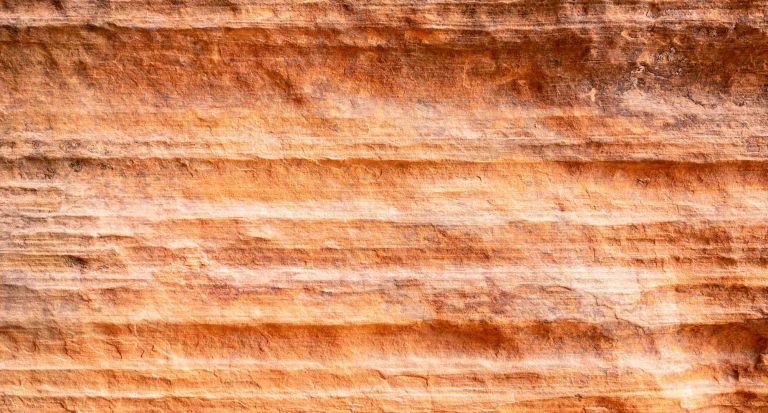 A close up of eroded and layered sandstone outcrop.